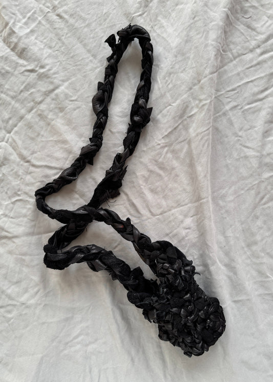 black leather small holster with long strap woven with many knots