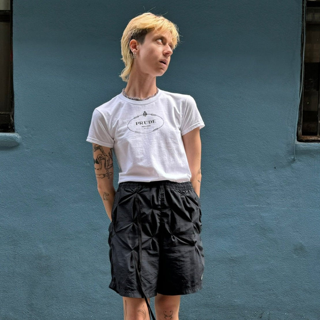 model in white t shirt with prude text in prada logo design