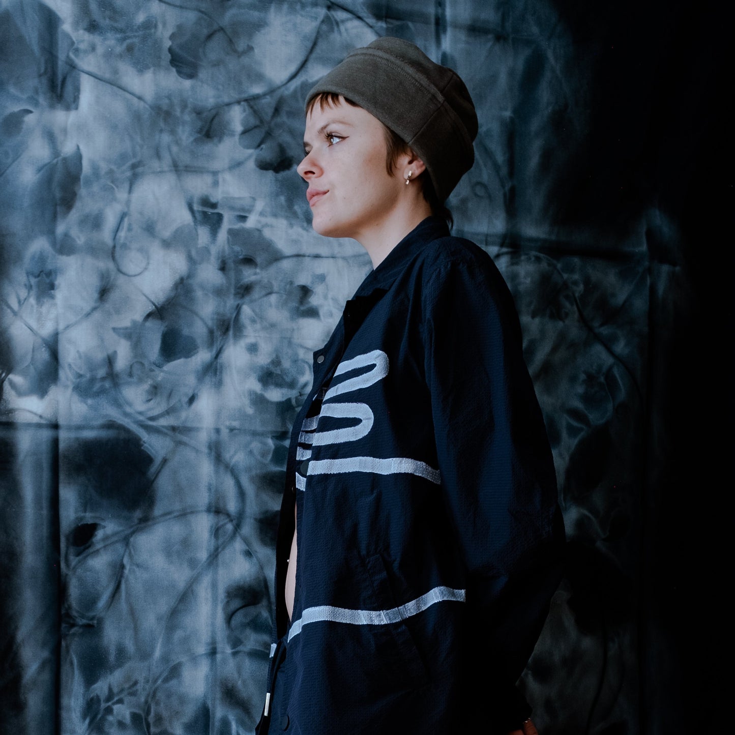 profile of model wearing an olive green cuffed cap