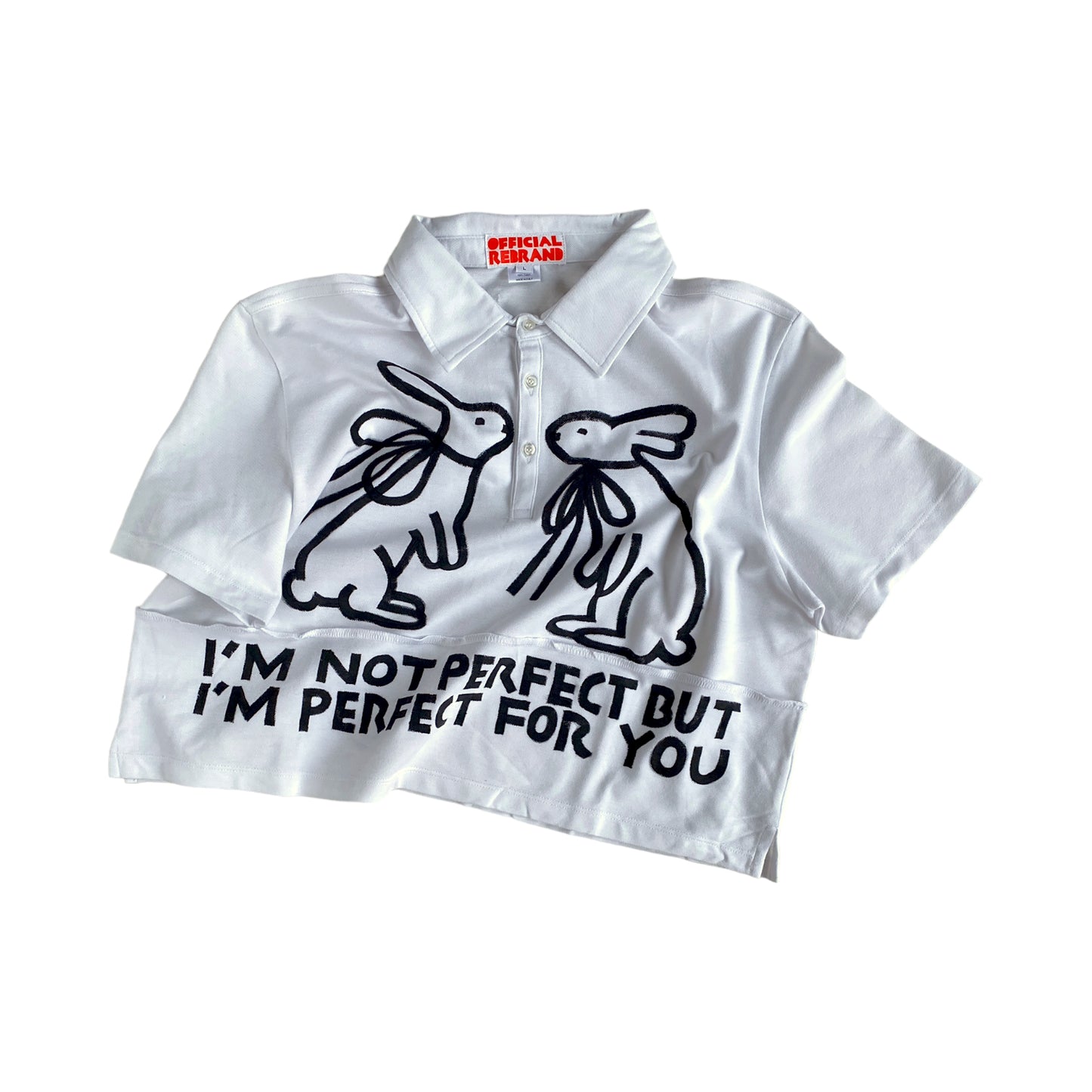 cropped white collared polo shirt with two black hand painted rabbits facing each other and black text reading I'M NOT PERFECT BUT I'M PERFECT FOR YOU
