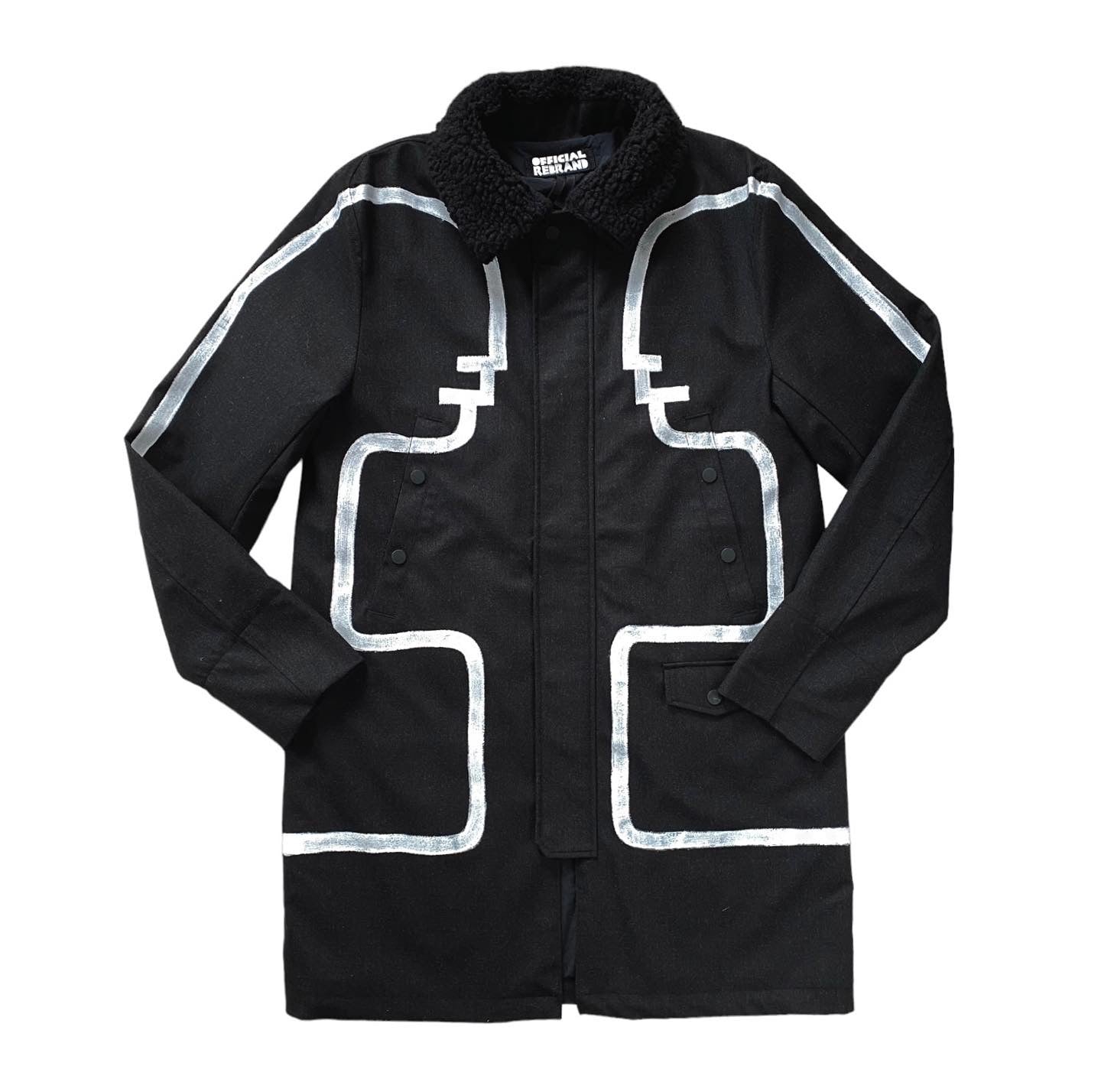 black long winter coat with faux shearling collar and white conversation figures hand painted to face each other across the jacket's front and arms