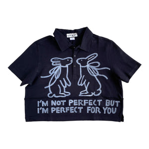 Open image in slideshow, cropped black collared polo shirt with two white hand painted rabbits facing each other and white text reading I&#39;M NOT PERFECT BUT I&#39;M PERFECT FOR YOU
