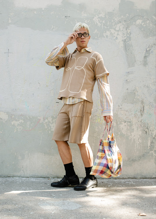 model wearing bleached light brown sweatshirt T with 11385 over striped button down