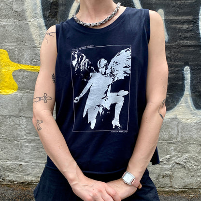 Model wearing navy blue tank top with white screen-printed claud cahun kneeling angel image and text reading ANGELS HAVE NO GENDER at the top and OFFICIAL REBRAND at the bottom