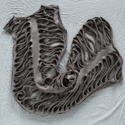 sliced ribs dress laid out on a gray backdrop with holes throughout looking like ribs