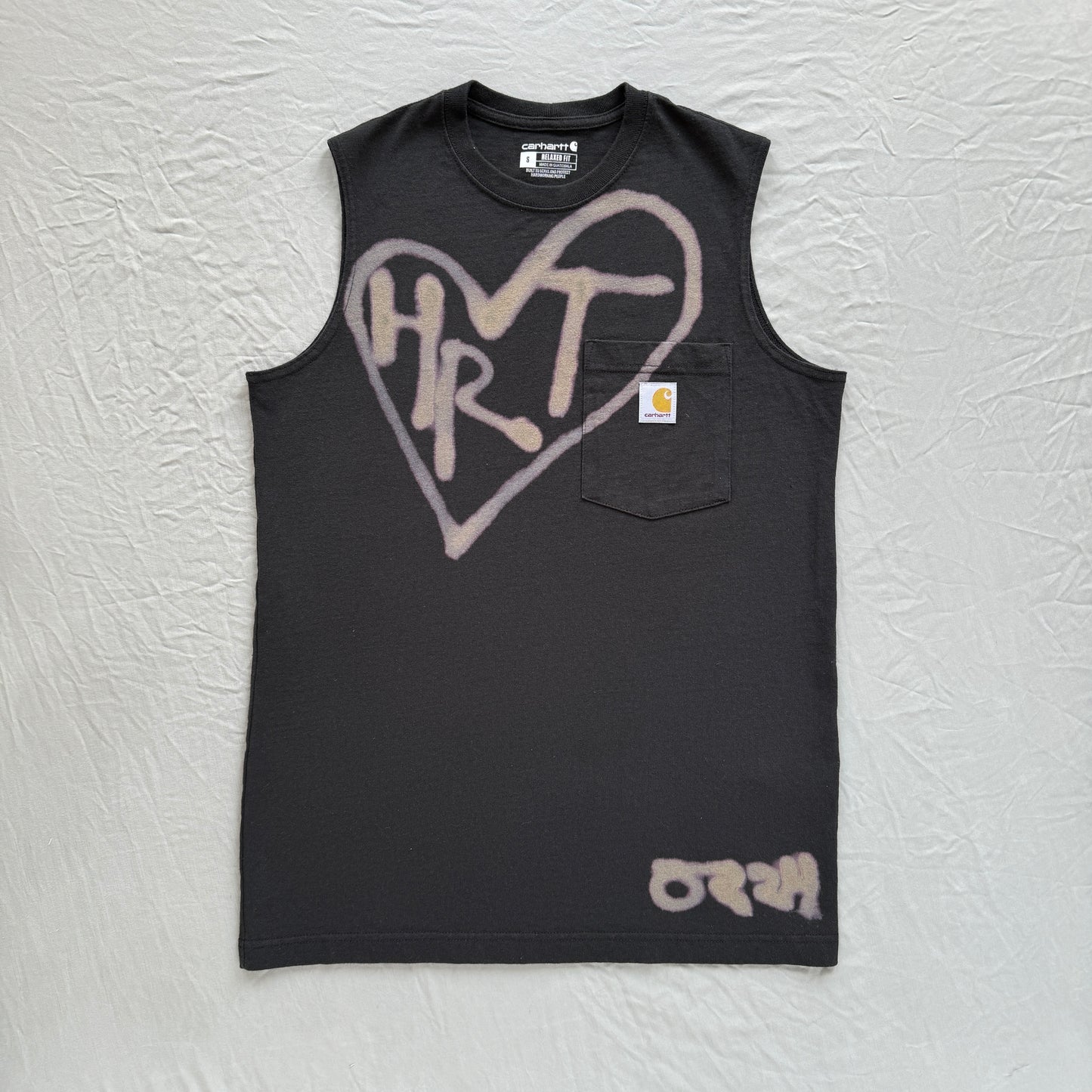 black carhartt tank with pocket on gray background with bleach heart and bleach text reading HRT. 