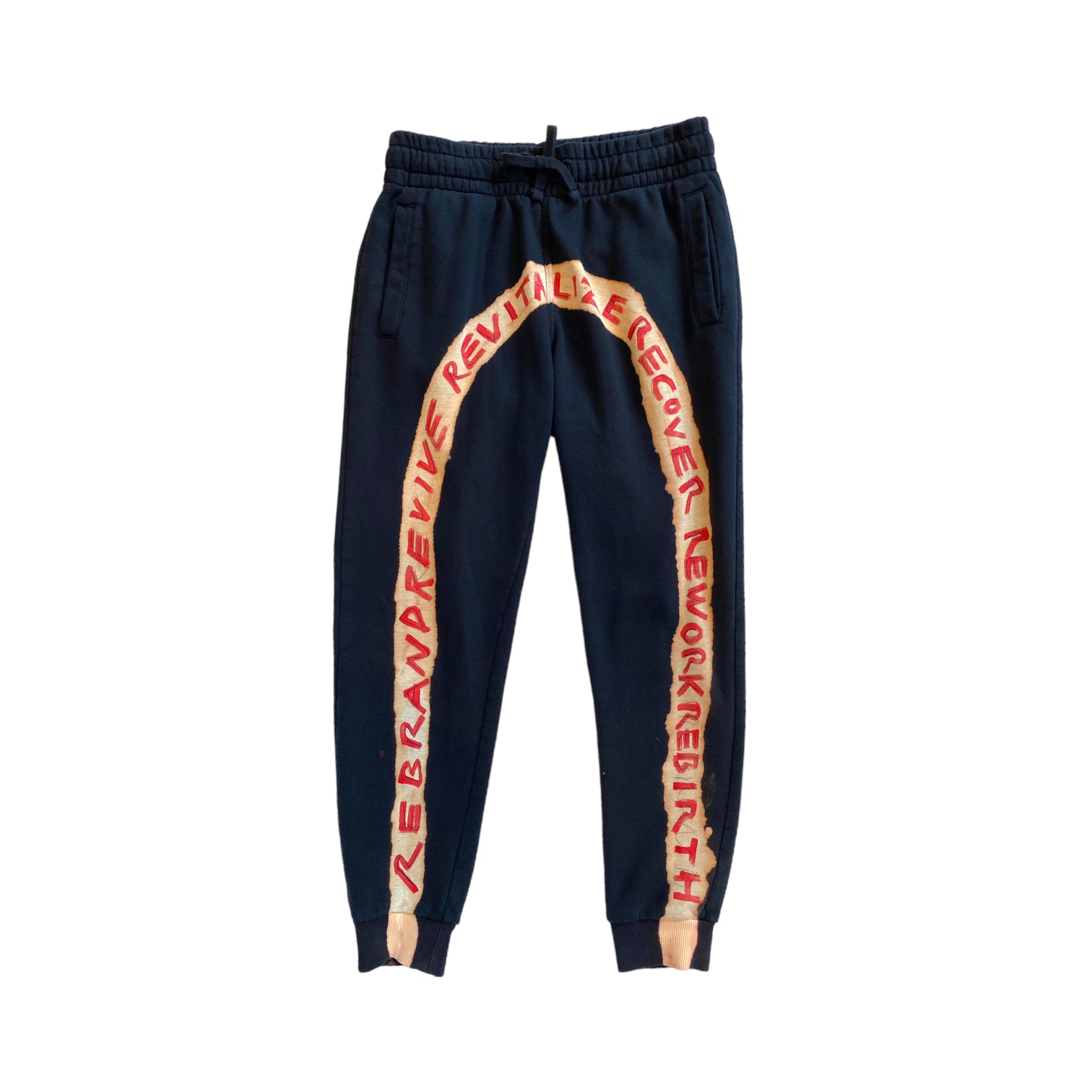 Black sweatpants with bleached arch and hand-painted red text across the front reading REBRAND REVIVE REVITALIZE RECOVER REWORK REBIRTH