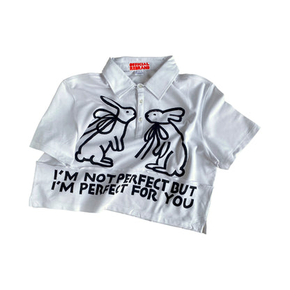 cropped white collared polo shirt with two black hand painted rabbits facing each other and black text reading I'M NOT PERFECT BUT I'M PERFECT FOR YOU 