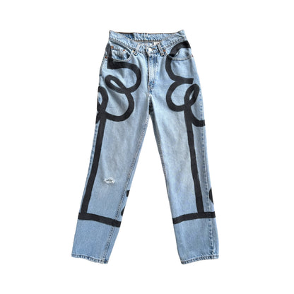 Denim pants with two large black flowers and stems painted across the front, sides, and back of the pants