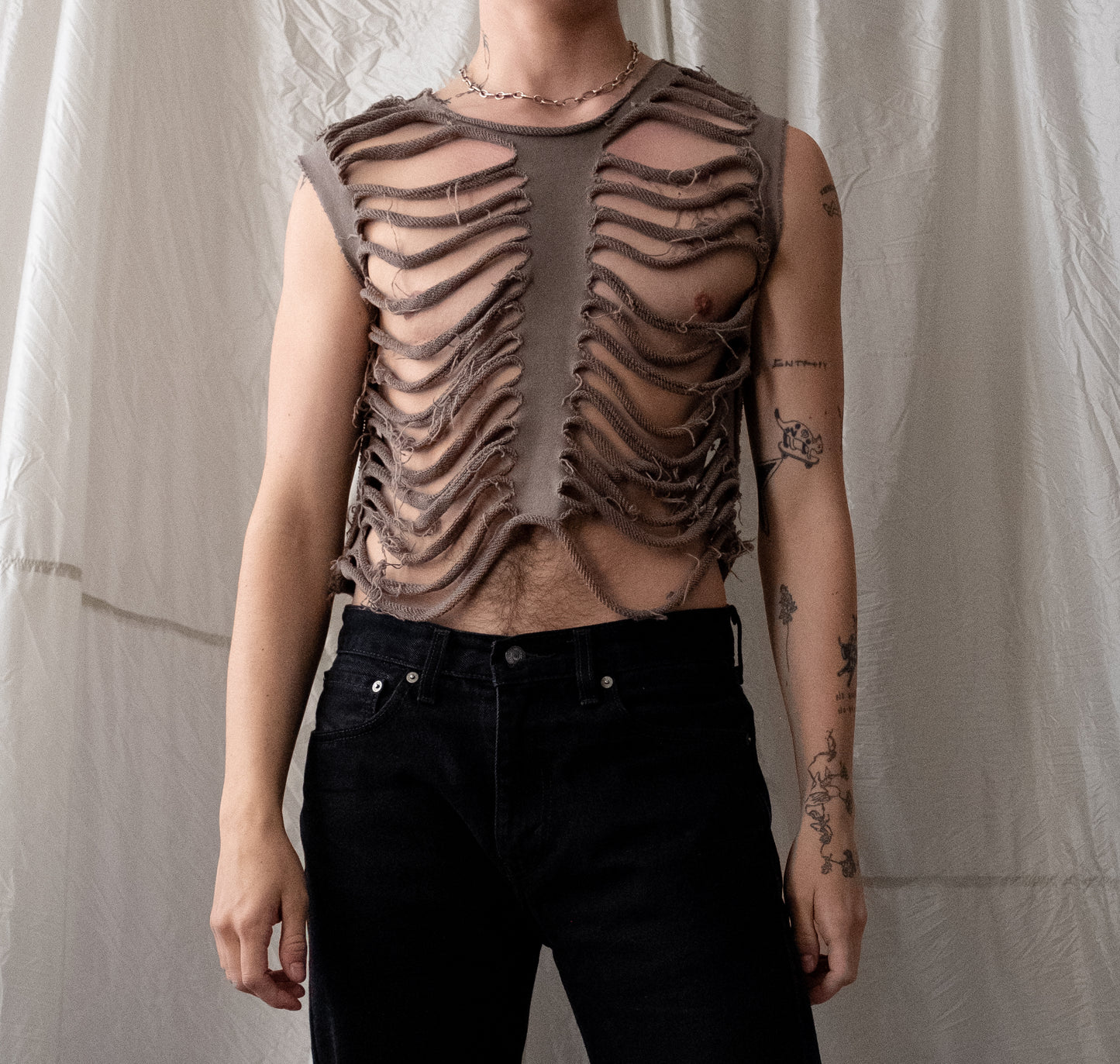 model wearing slate colored sliced french terry tank with cuts to look like ribs