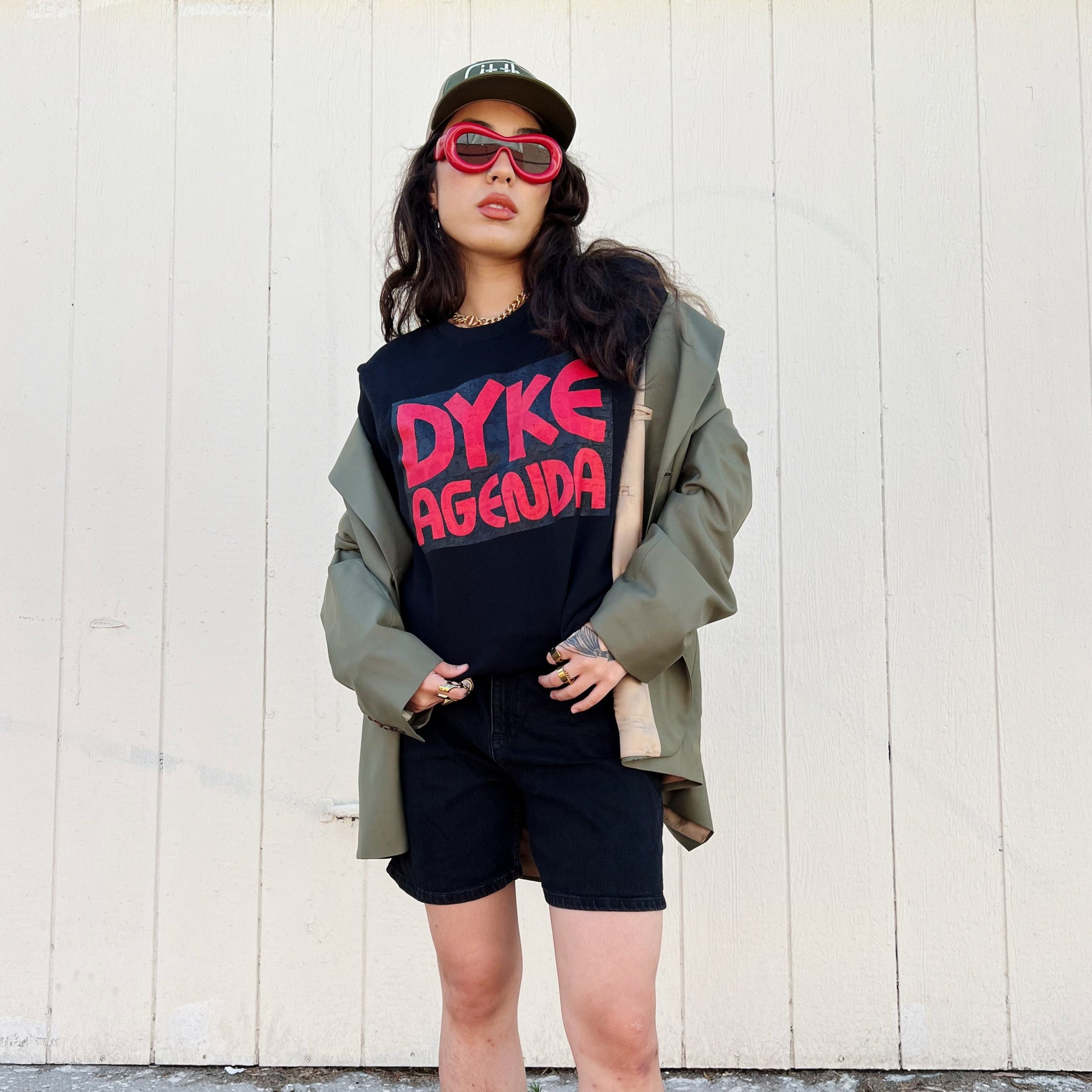 model HINA wearing black crew neck sweatshirt with red screen printed text reading DYKE AGENDA