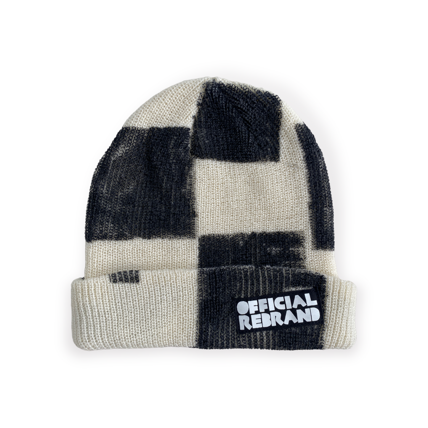 cream beanie with hand painted black checkered squares and a black tag with white text reading OFFICIAL REBRAND on the hat's cuff