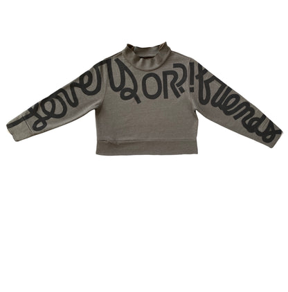 olive green mockneck with hand-painted cursive text across the arms and chest reading LOVERS OR?! FRIENDS in black