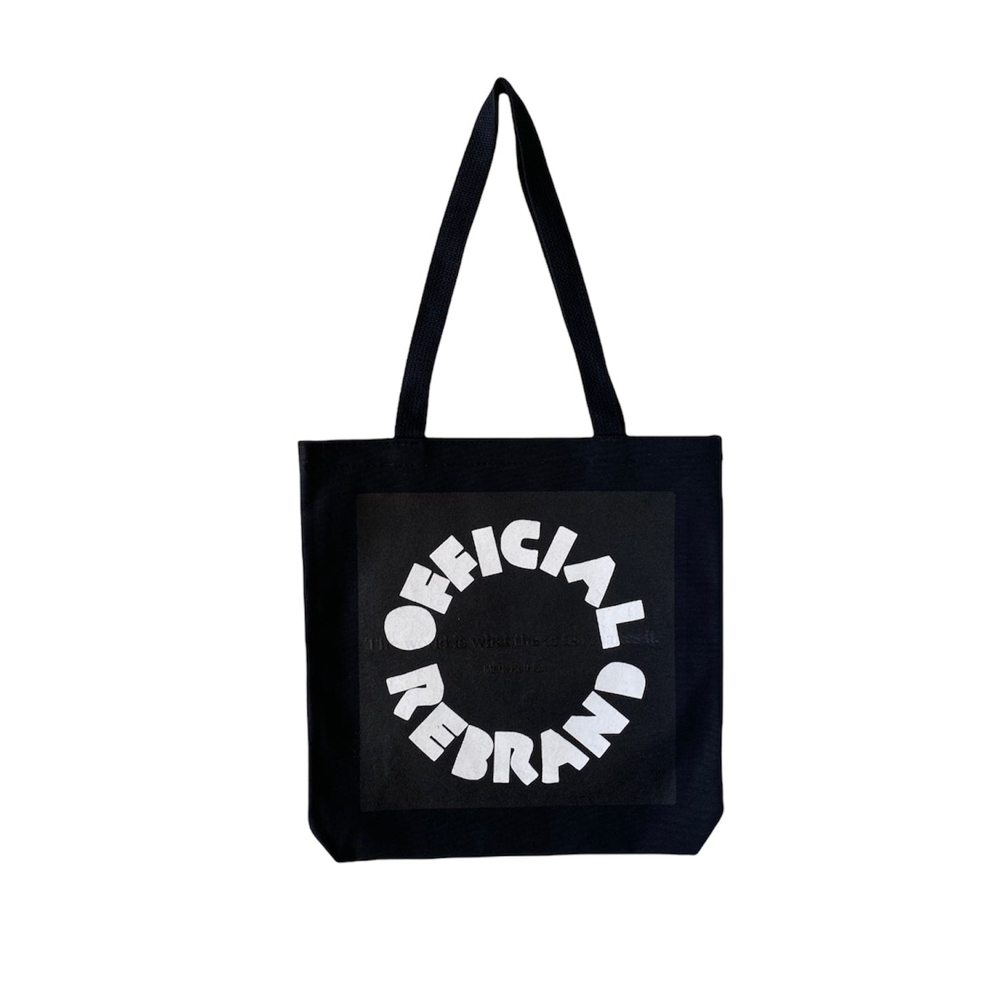 back of black tote bag with white circular text reading OFFICIAL REBRAND  