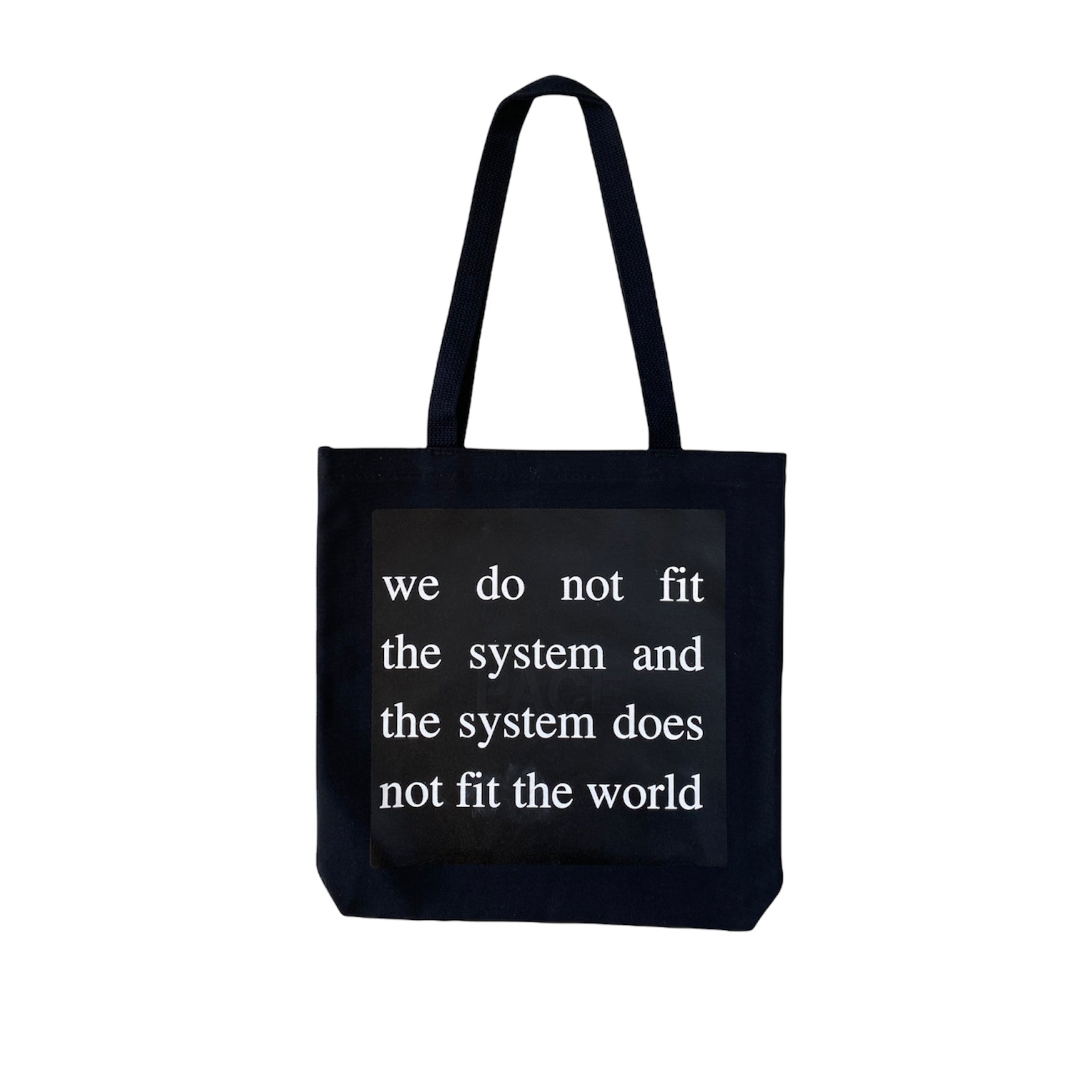 black tote bag with white screen printed text reading we do not fit the system and the system does not fit the world