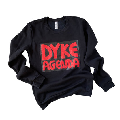 black crew neck sweatshirt with red screen printed text reading DYKE AGENDA