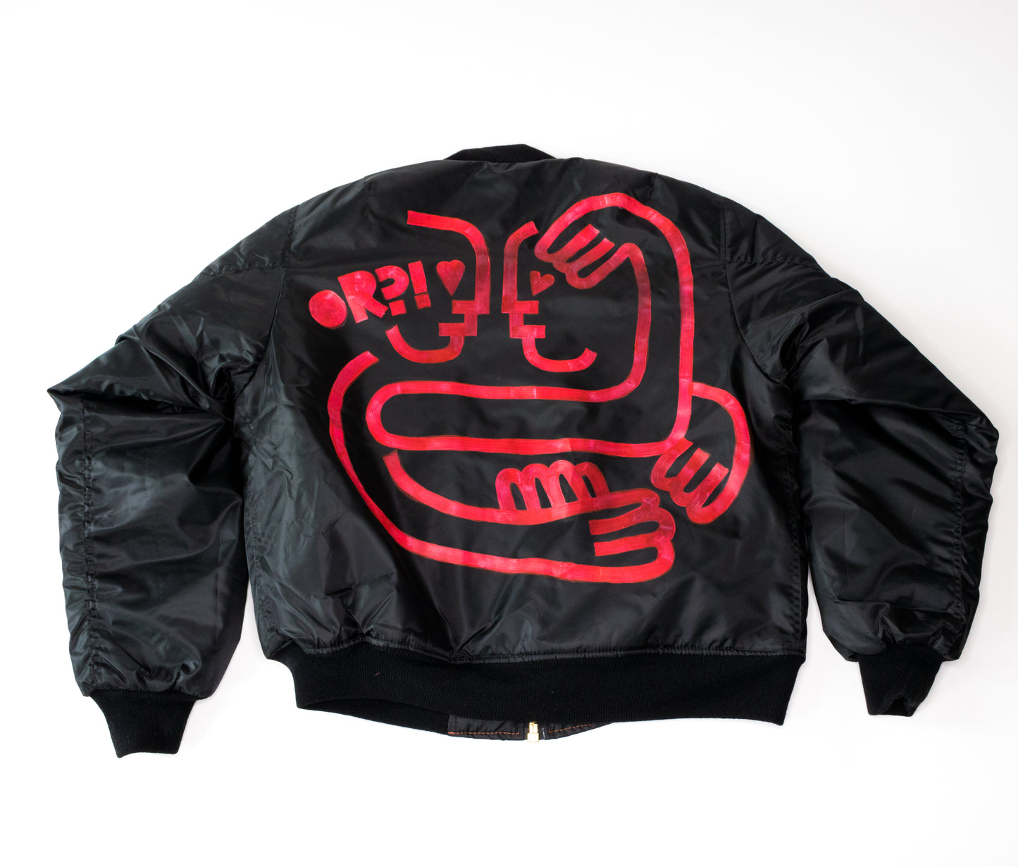 back of black bomber jacket with red hand-painted minimal design of two lovers embracing and text reading OR?!